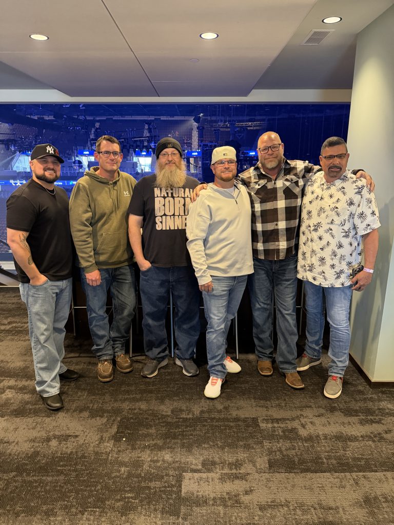 Eastep friends posing together at a Shinedown concert