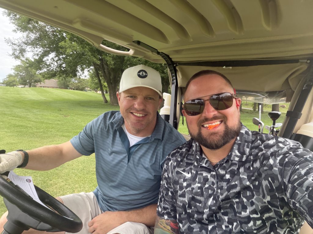 Ryan Eastep and Jerry McDonald together in a golf cart
